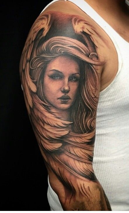Depicting a serene woman's face with angelic wings, this tattoo combines elements of protection and beauty.