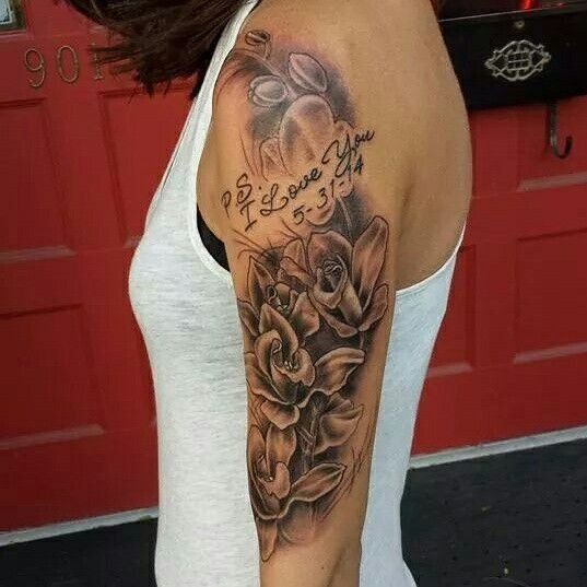 This tattoo features a stunning arrangement of roses with a heartfelt message: "P.S.