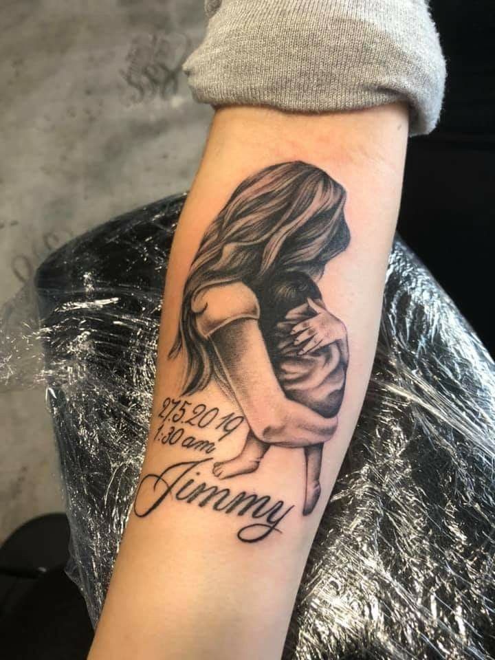A touching depiction of a mother embracing her child, this tattoo is filled with emotion and detail.