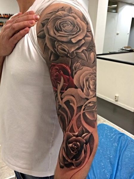 Featuring a series of roses along the arm, this sleeve tattoo symbolizes love and beauty.