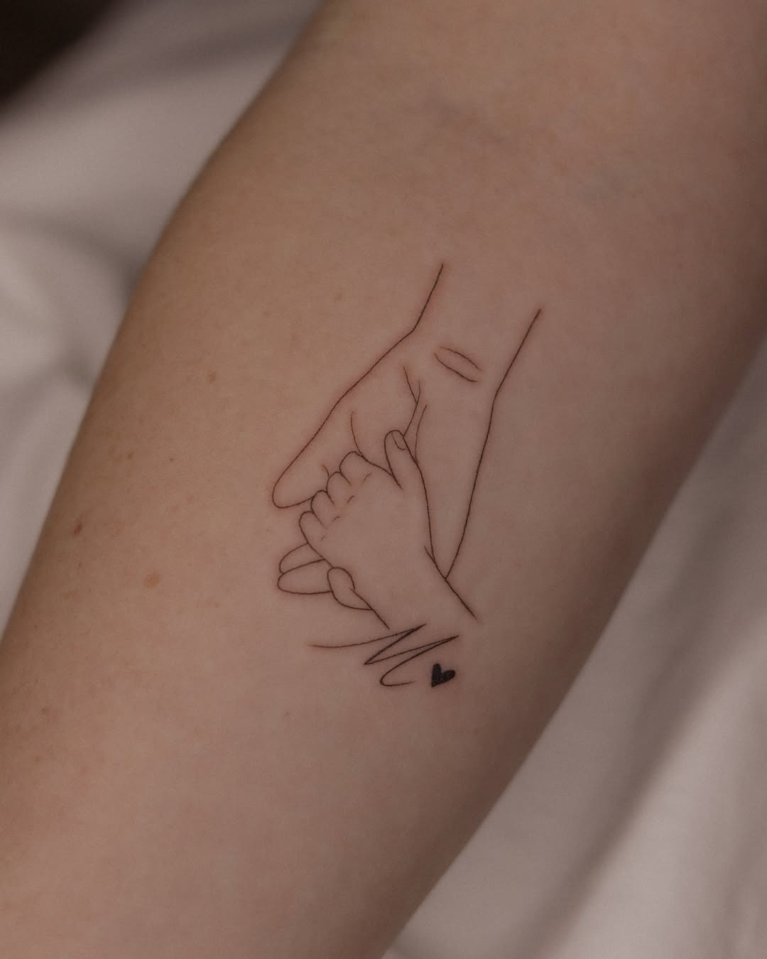 Elegant tattoo of a mother and child's hands Tattoo Design