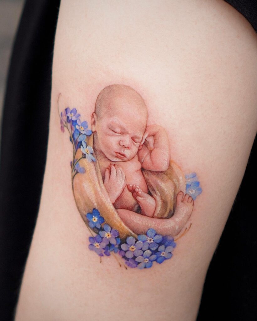 Sleeping Baby with Forget-Me-Nots Tattoo Tattoo Design