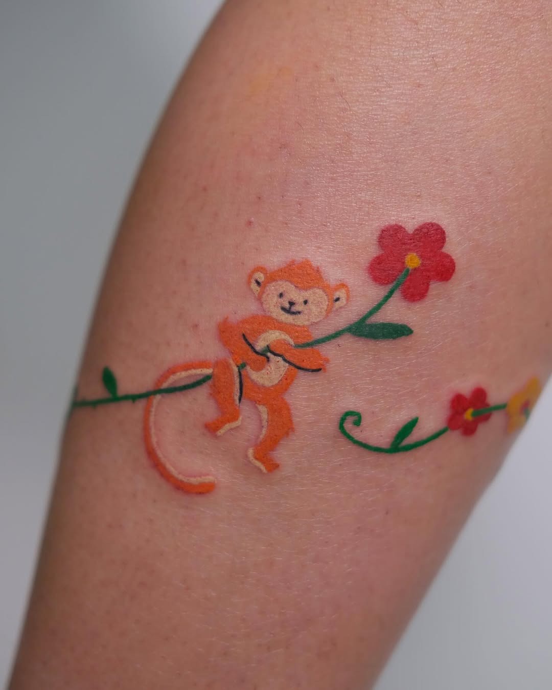 Charming monkey tattoo with floral elements Tattoo Design