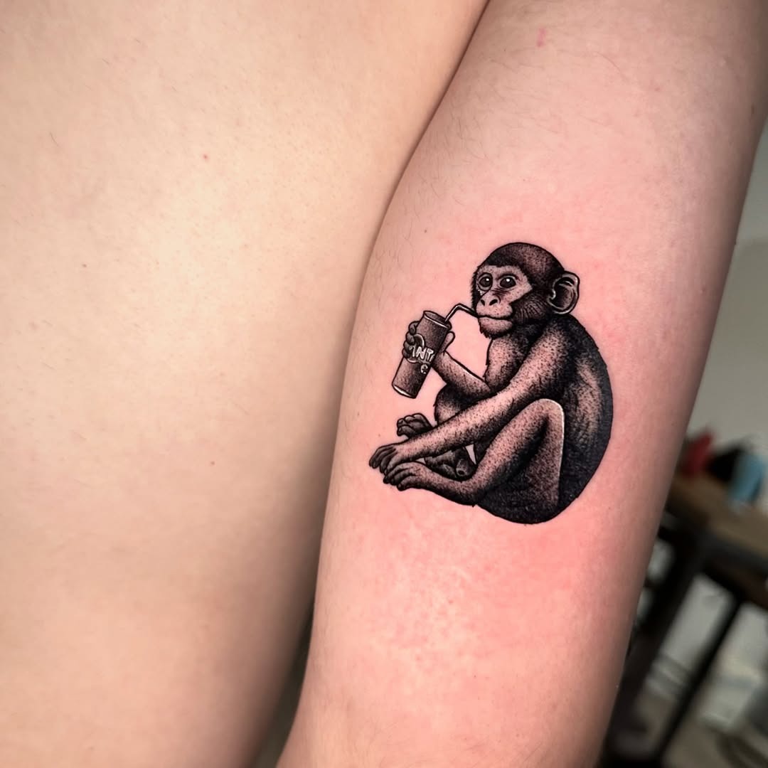 Playful monkey enjoying a drink tattoo Tattoo Design