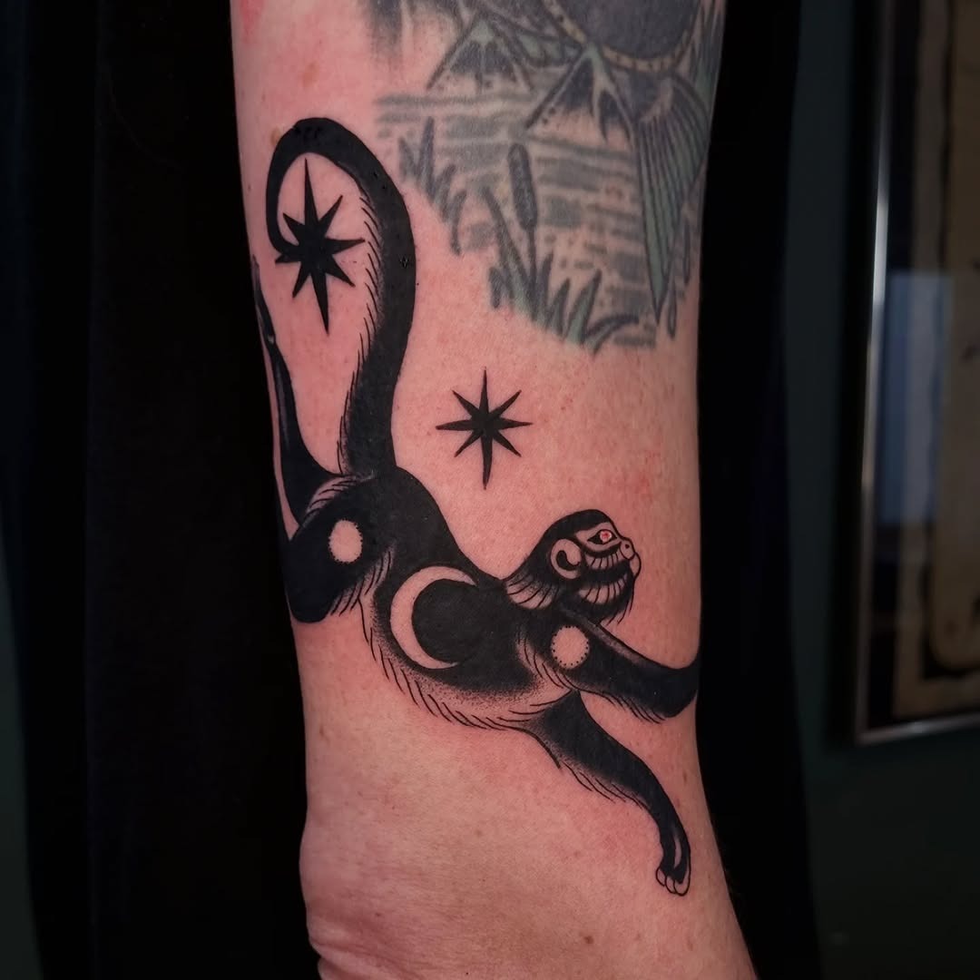 Playful monkey tattoo with celestial elements Tattoo Design