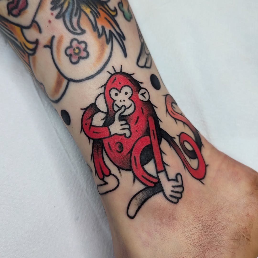 Vibrant monkey tattoo with playful expression Tattoo Design