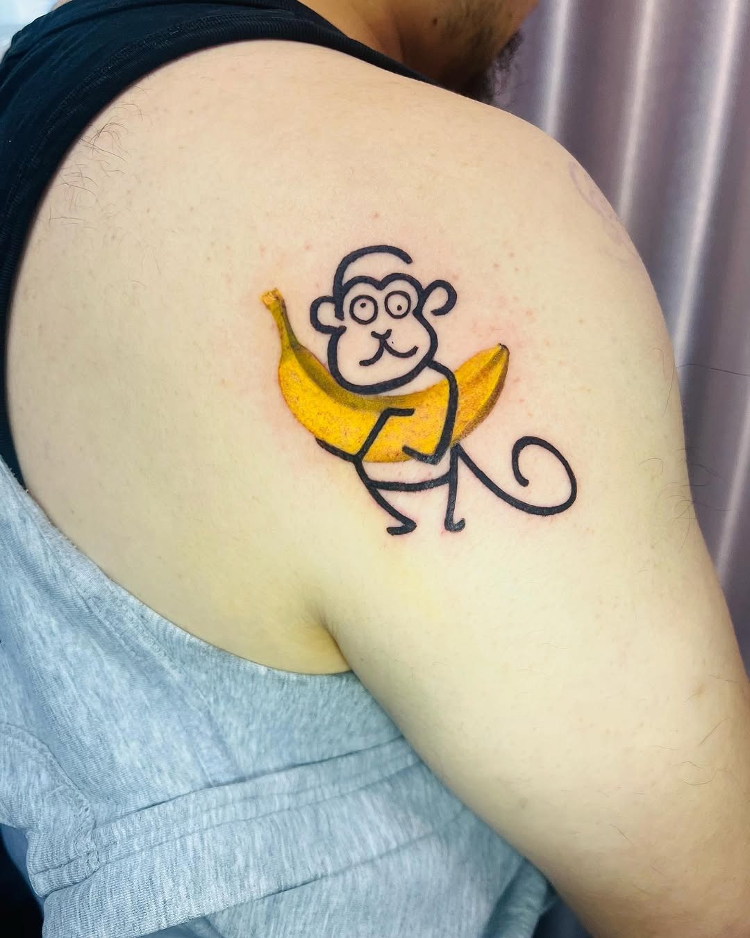 Whimsical monkey tattoo holding a banana Tattoo Design