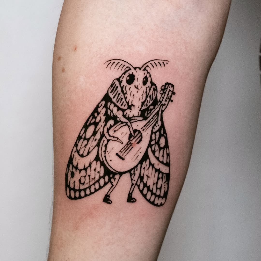 A charming moth playing a tiny guitar Tattoo Design