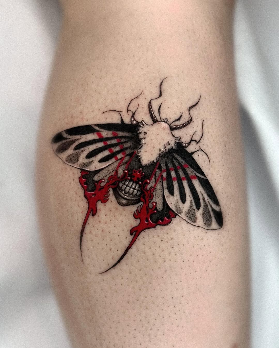 Bold Moth Tattoo with Striking Red Accents Tattoo Design