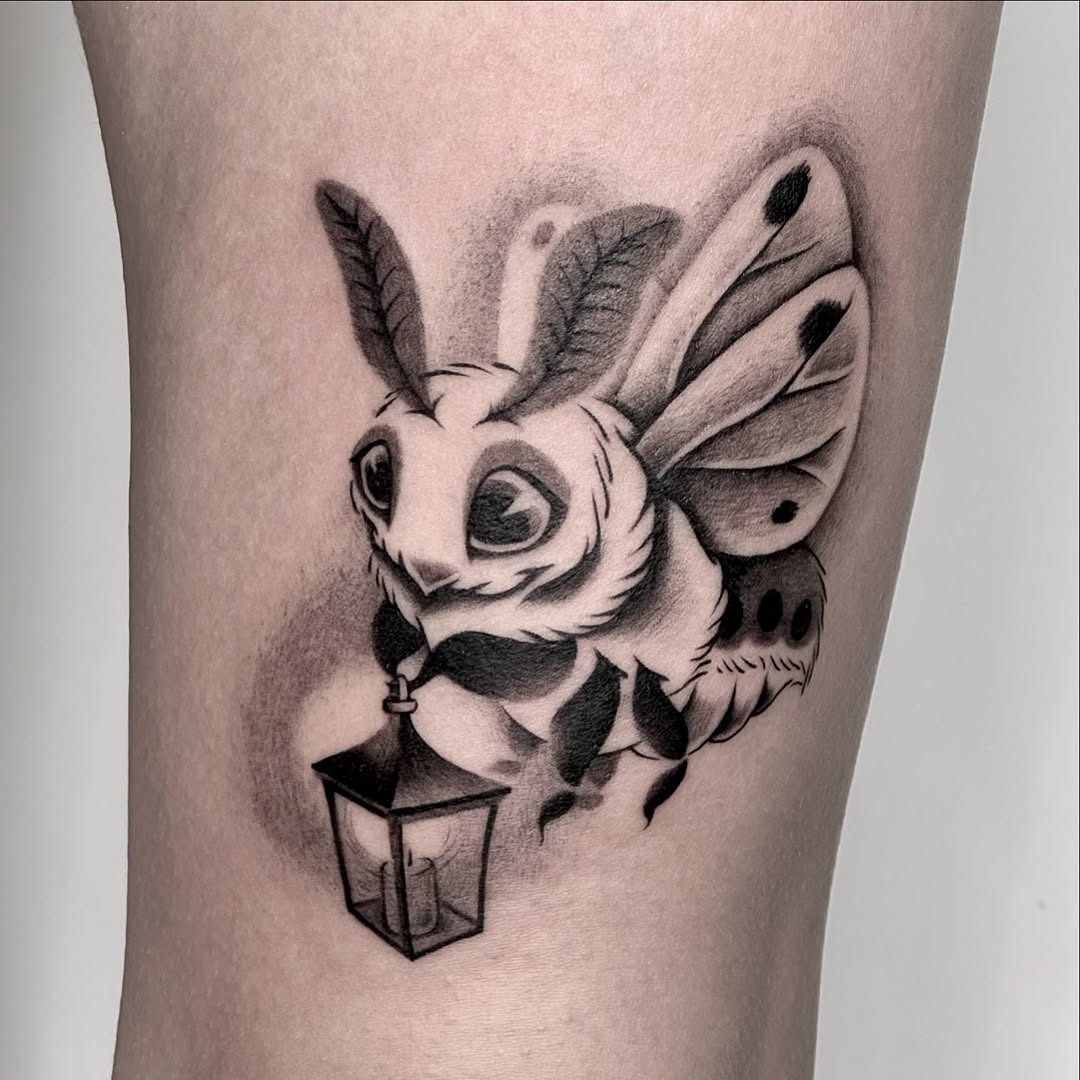 Charming moth tattoo with a whimsical lantern Tattoo Design