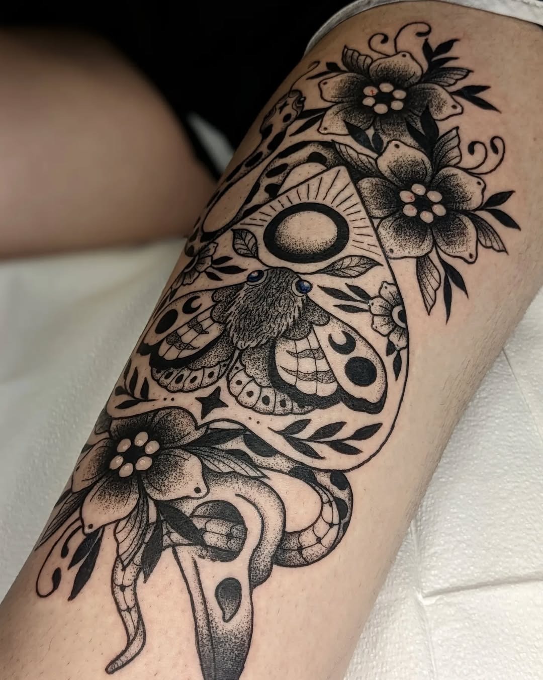 Elegant moth tattoo adorned with floral details Tattoo Design