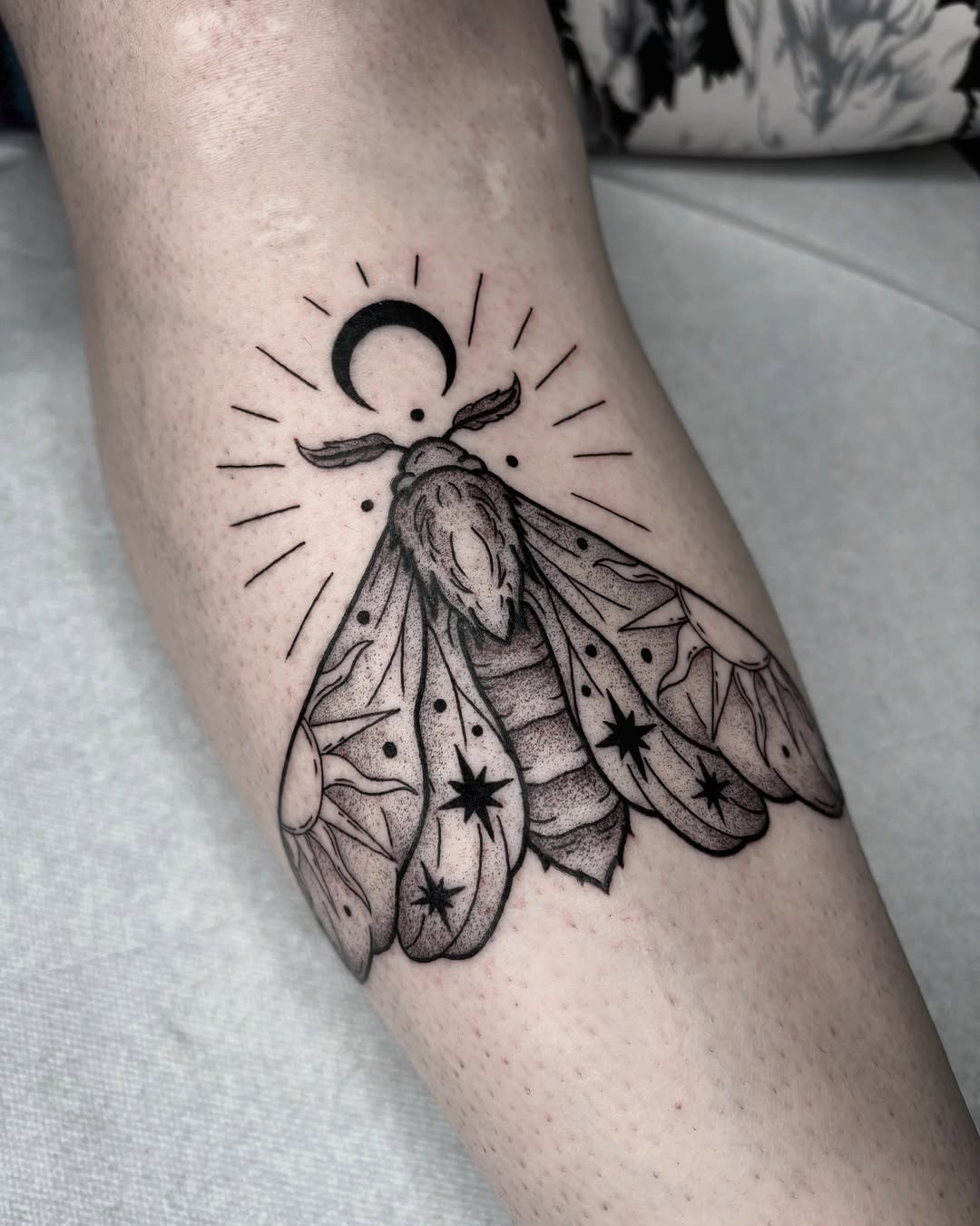 Elegant moth tattoo with celestial elements Tattoo Design