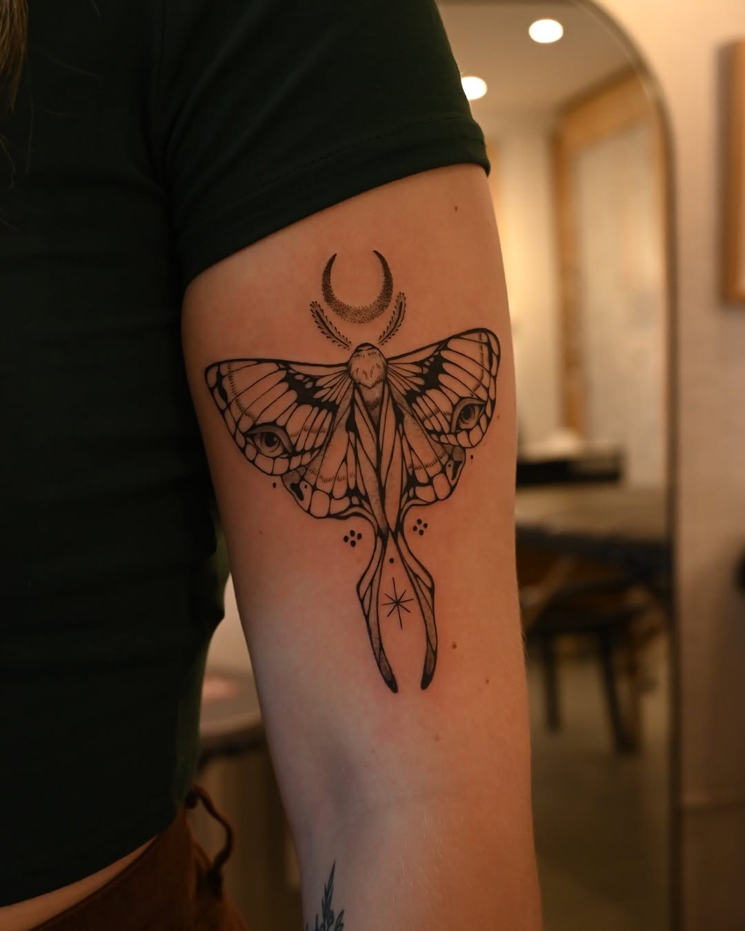 Elegant moth tattoo with celestial elements Tattoo Design