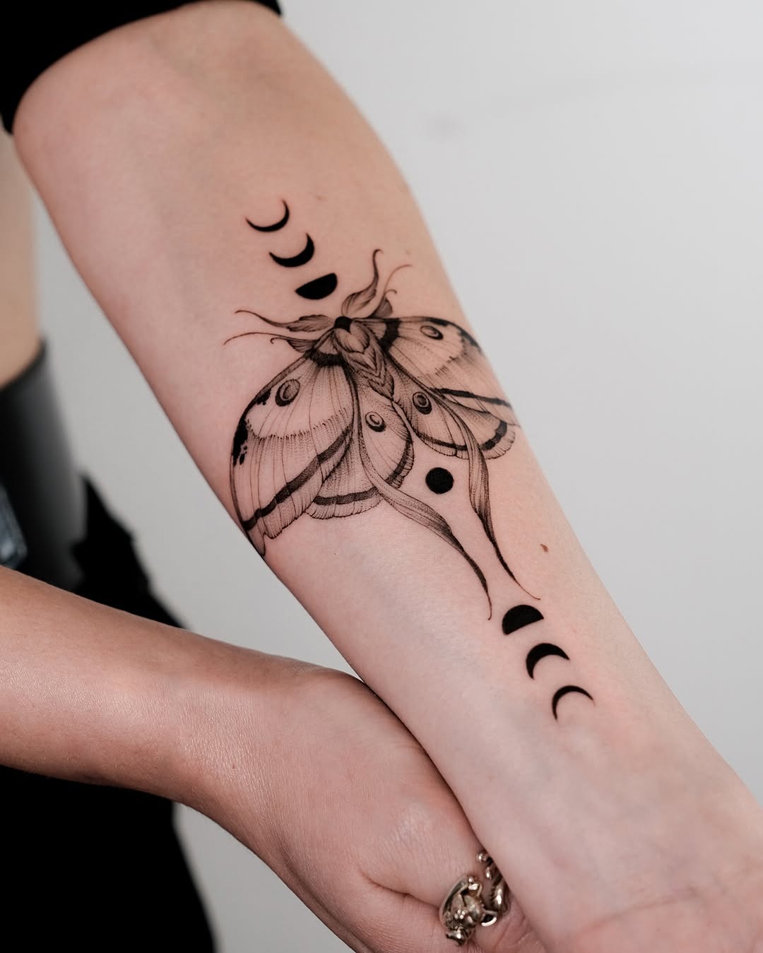 Elegant moth tattoo with moon phase motifs Tattoo Design