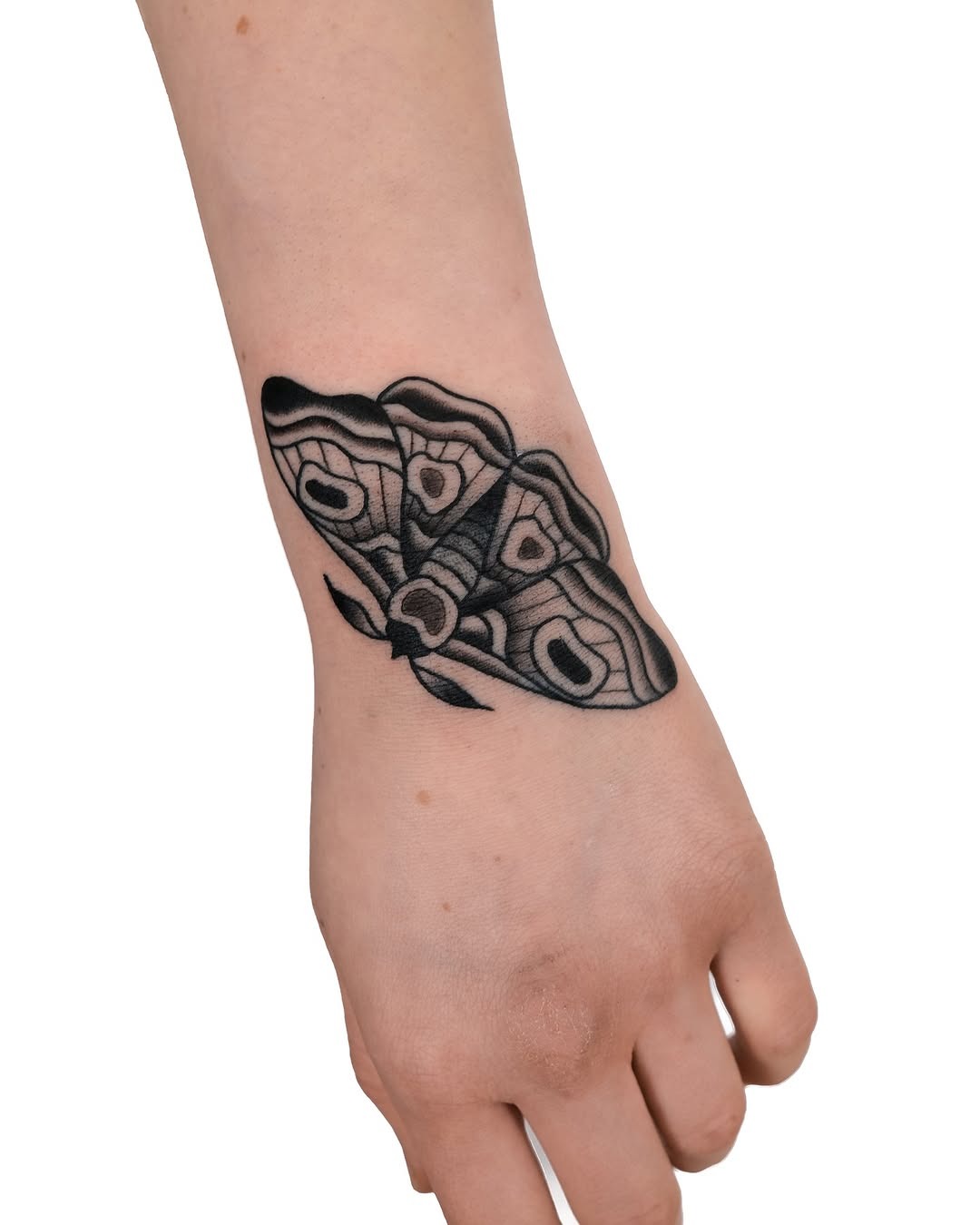 Intricate black line moth tattoo on forearm Tattoo Design