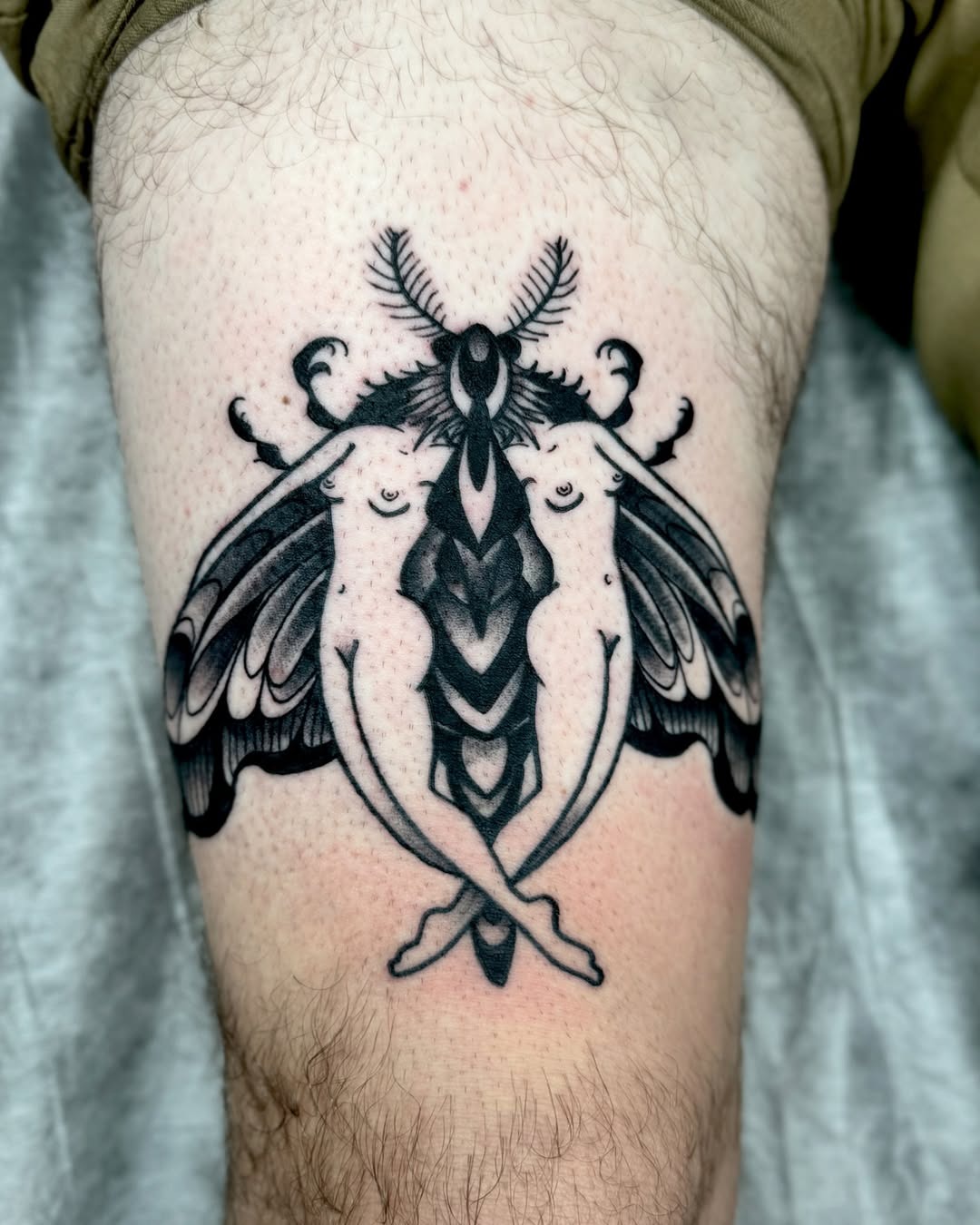 Intricate black moth tattoo with floral elements Tattoo Design