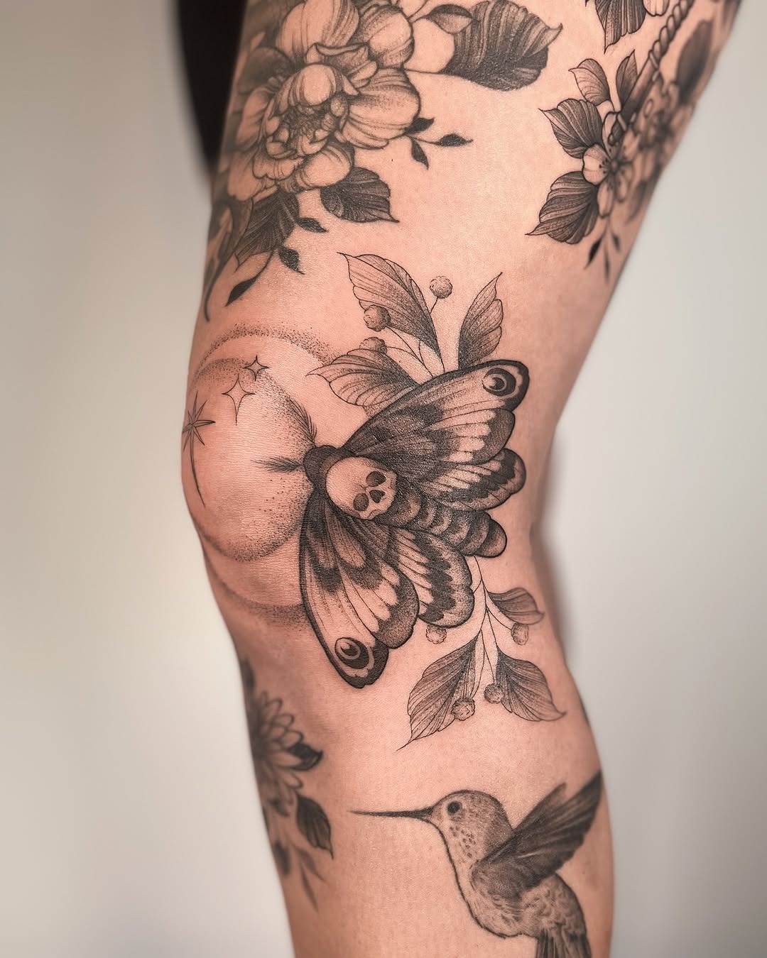 Intricate moth design with floral elements Tattoo Design