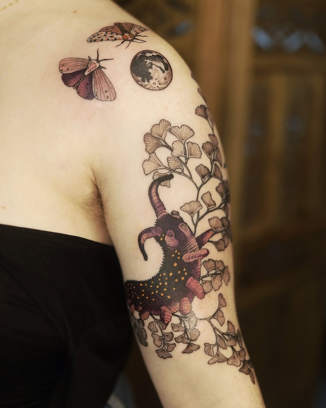 Intricate moth tattoo with floral elements and moon. Tattoo Design