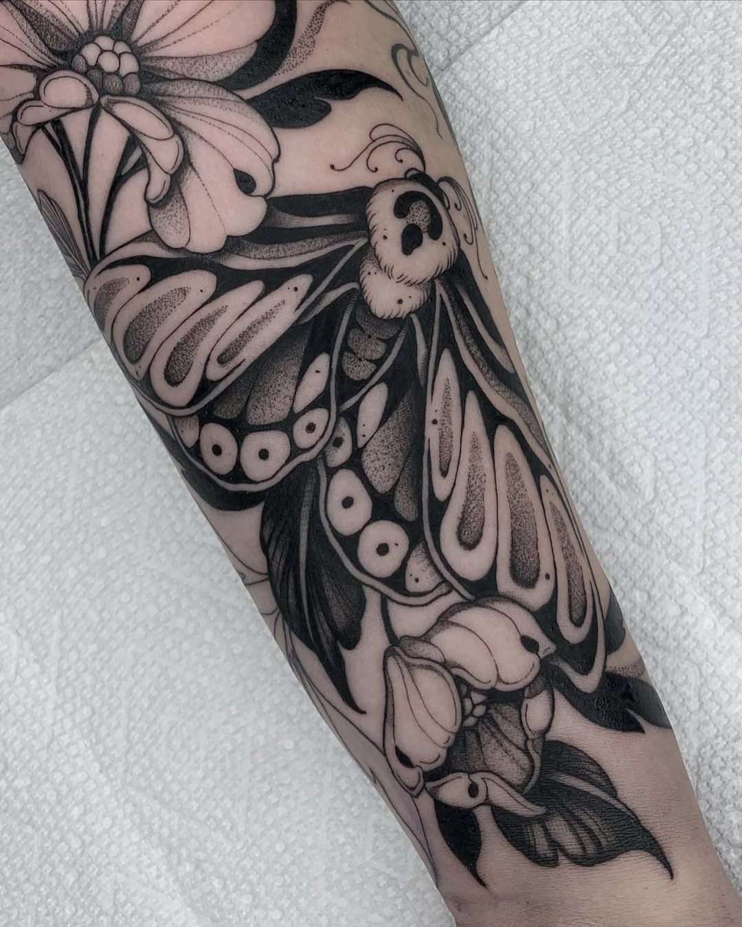 Intricate moth tattoo with floral elements Tattoo Design