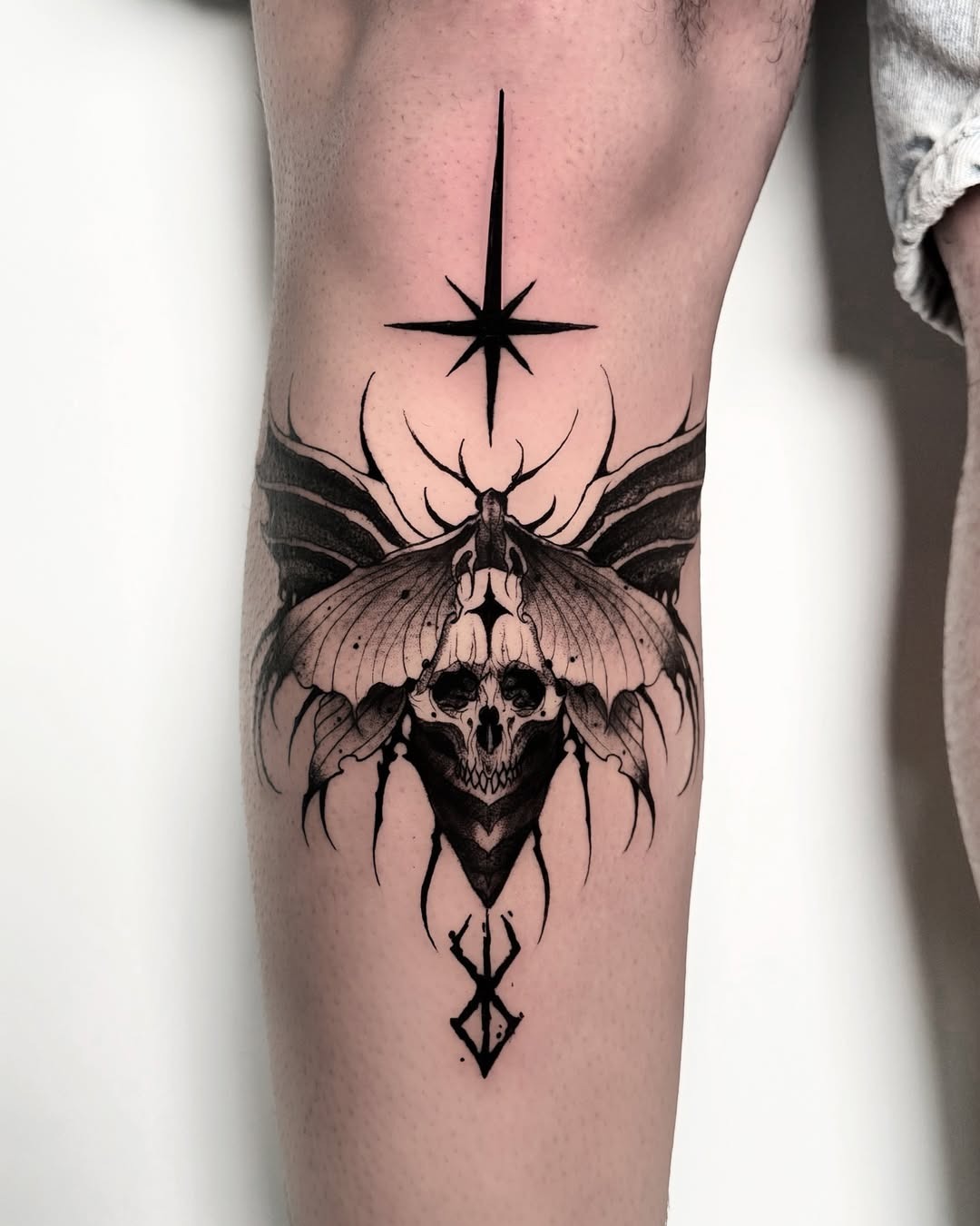 Intricate moth tattoo with striking skull design Tattoo Design