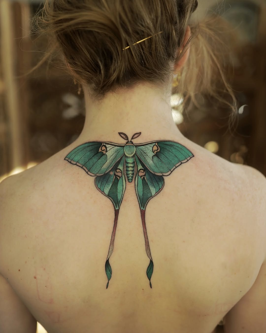 Stunning back moth tattoo with vibrant colors Tattoo Design