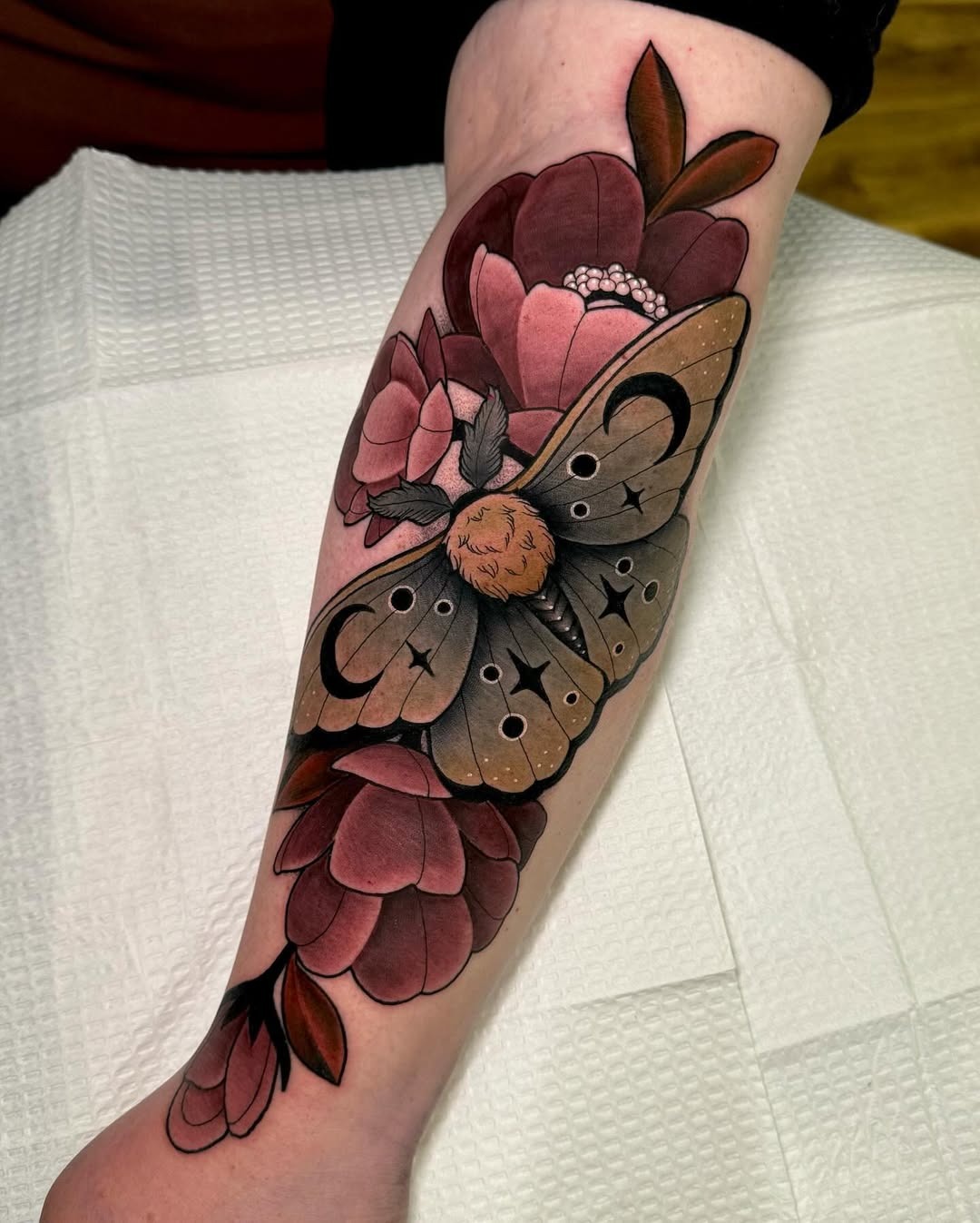 Stunning moth surrounded by vibrant flowers Tattoo Design