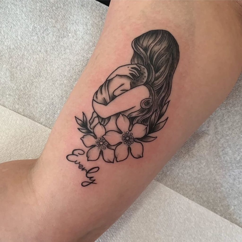 Mother and Child Surrounded by Flowers Tattoo Design