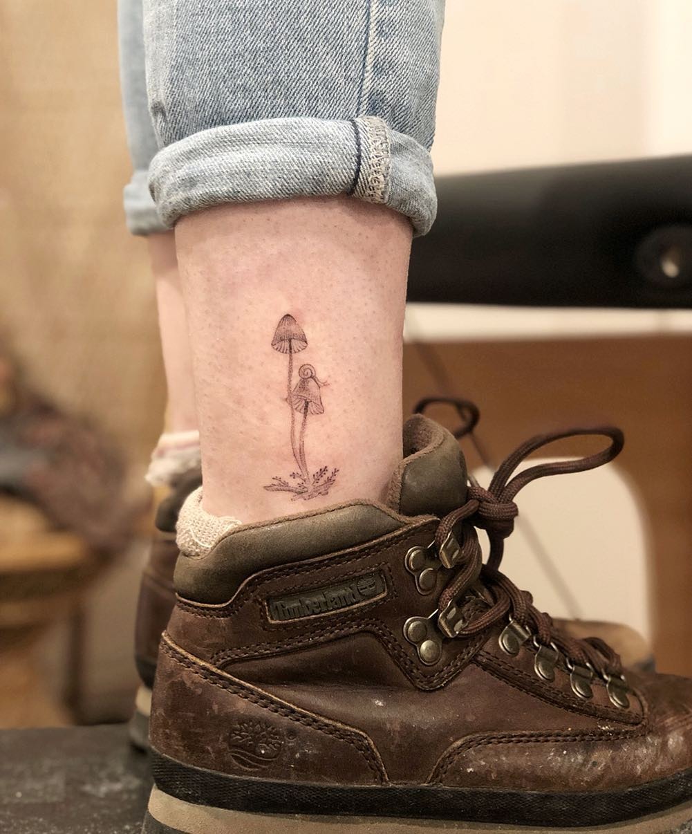 Elegant mushroom tattoo on ankle showcases nature’s beauty Tattoo Design