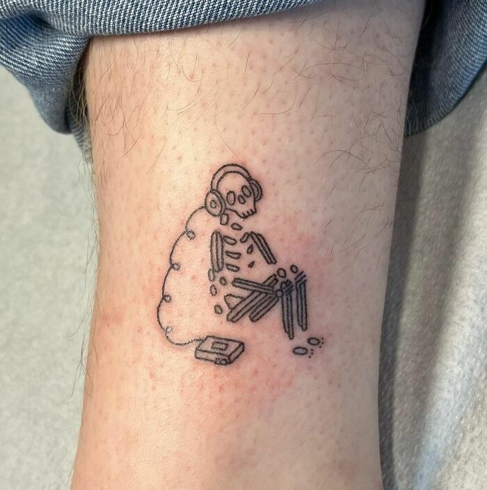 Minimalist Skeleton Listening to Music Tattoo Design