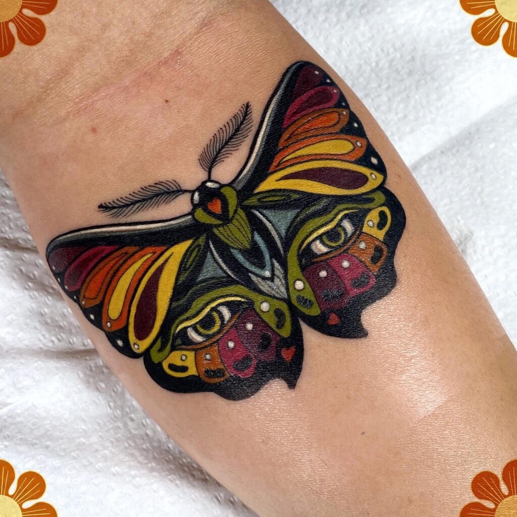 Colorful Moth Tattoo with Hidden Eyes Tattoo Design