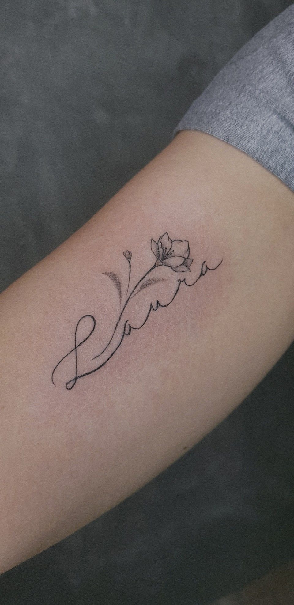 Fine Line Name With a Delicate Flower Tattoo Design