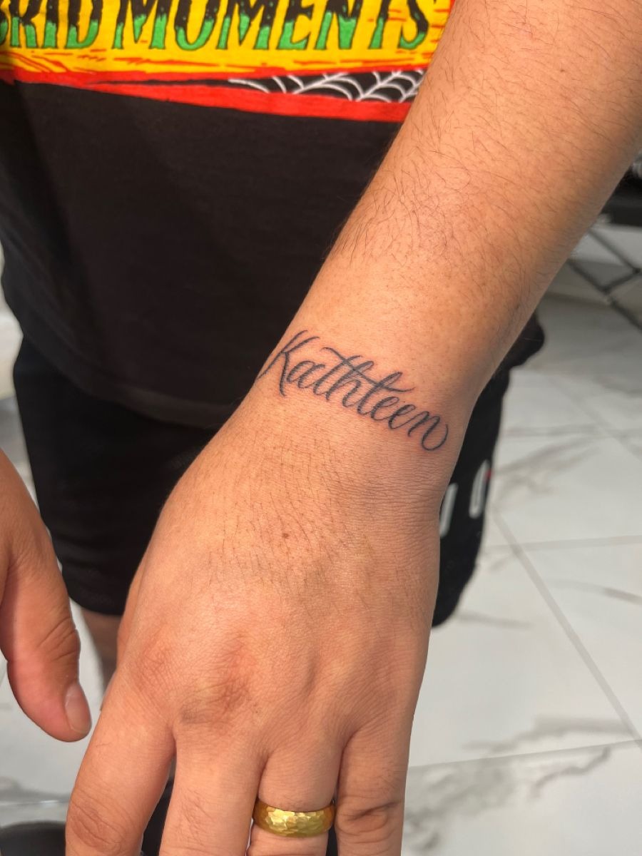 Kathleen Name Tattoo Near the Hand Tattoo Design