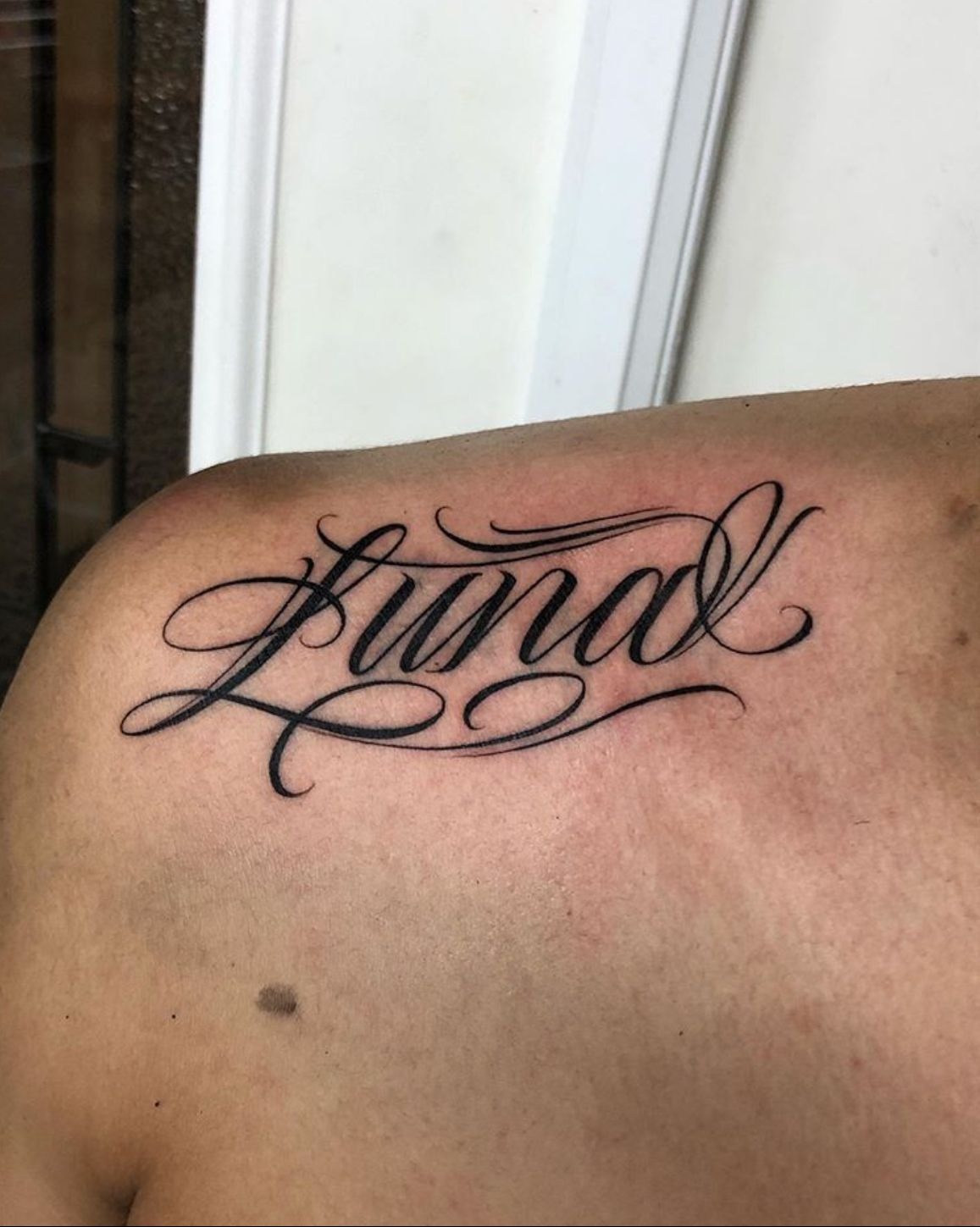 Shoulder Name Tattoo in Flowing Script Tattoo Design