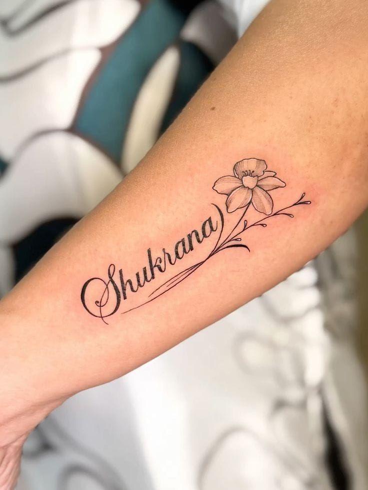 Shukrana Name Tattoo With a Delicate Flower Tattoo Design