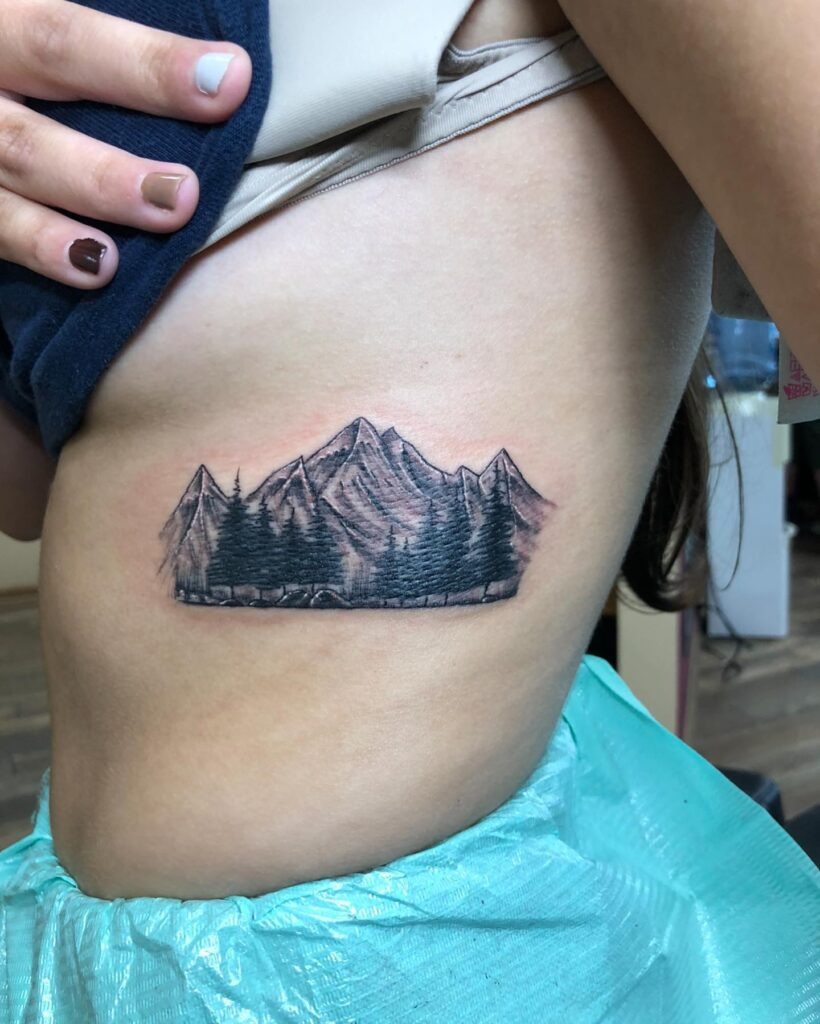 Mountain and Pine Tree Rib Tattoo Tattoo Design