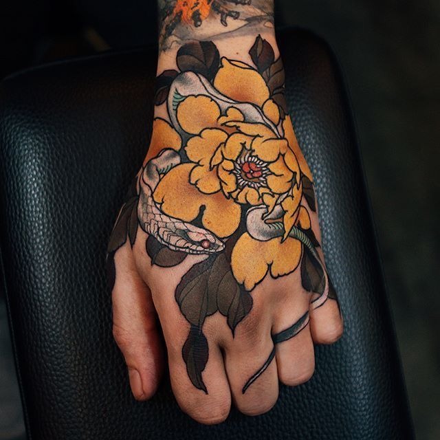 Snake and Floral Hand Tattoo: Power and Elegance Tattoo Design