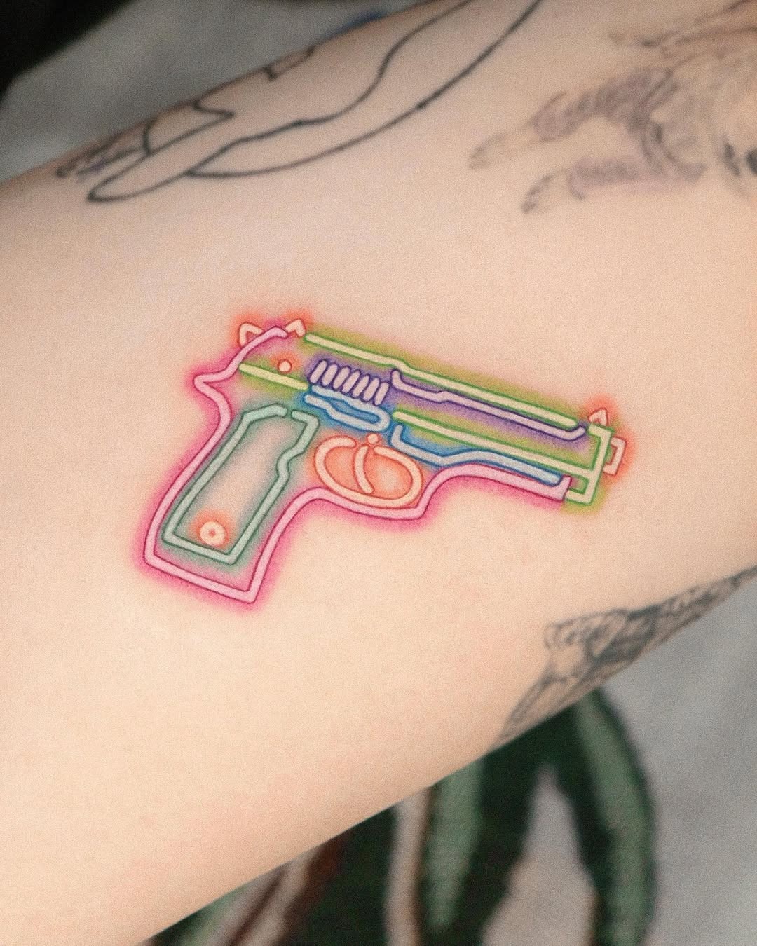 Vibrant neon gun tattoo with colorful outlines Tattoo Design
