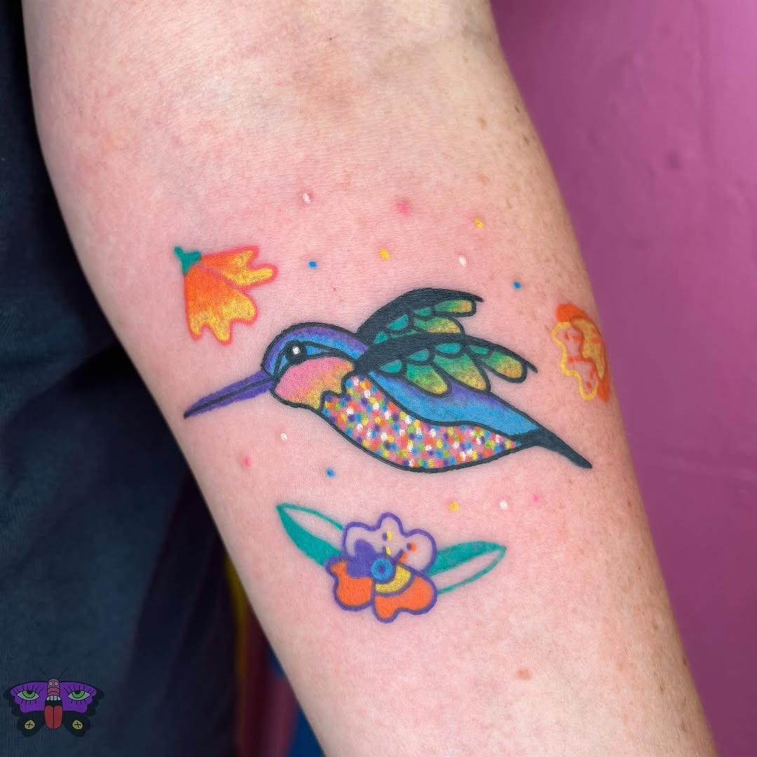 Vivid hummingbird with floral accents tattoo design Tattoo Design
