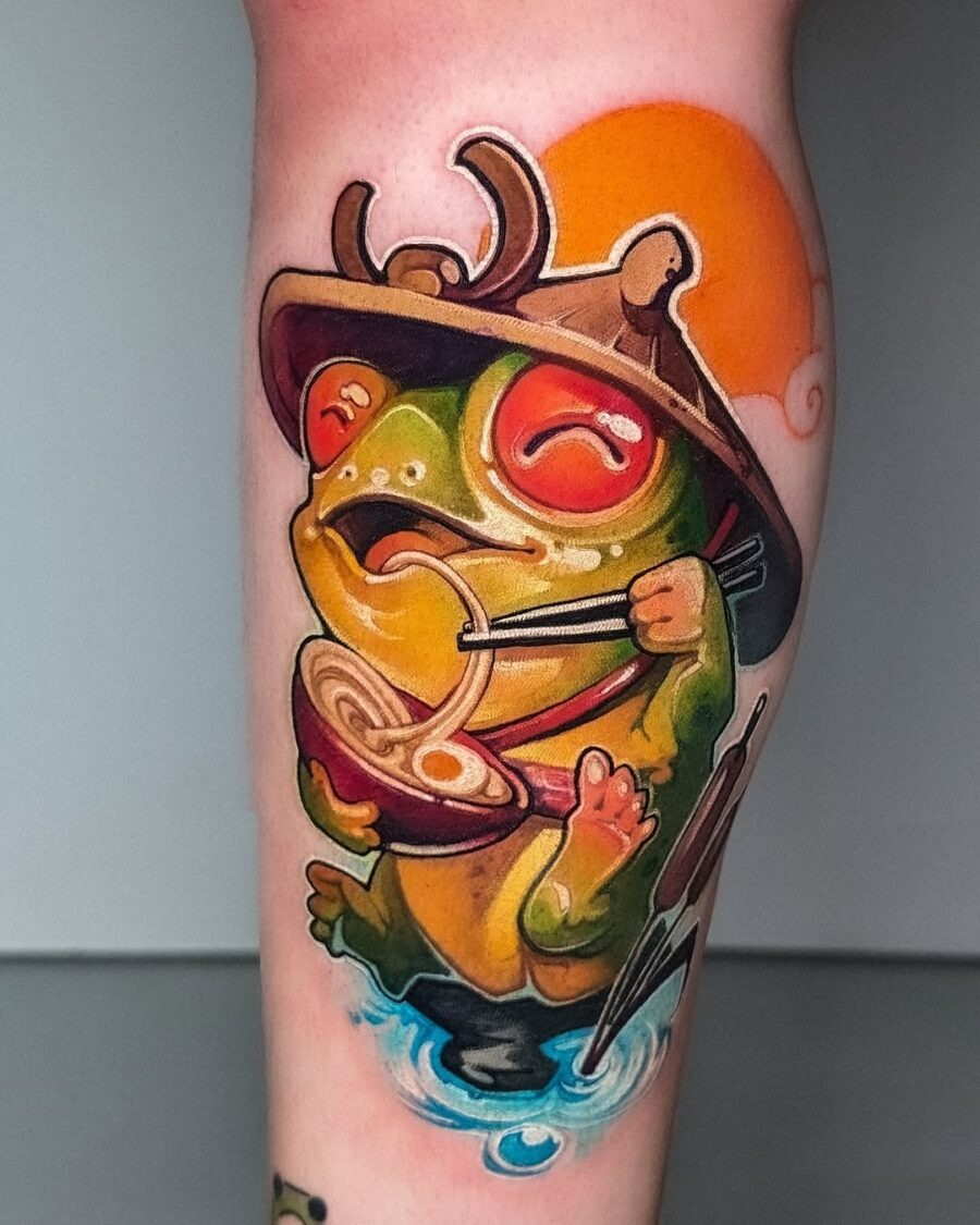 This tattoo showcases a cheerful frog savoring ramen, complete with chopsticks.