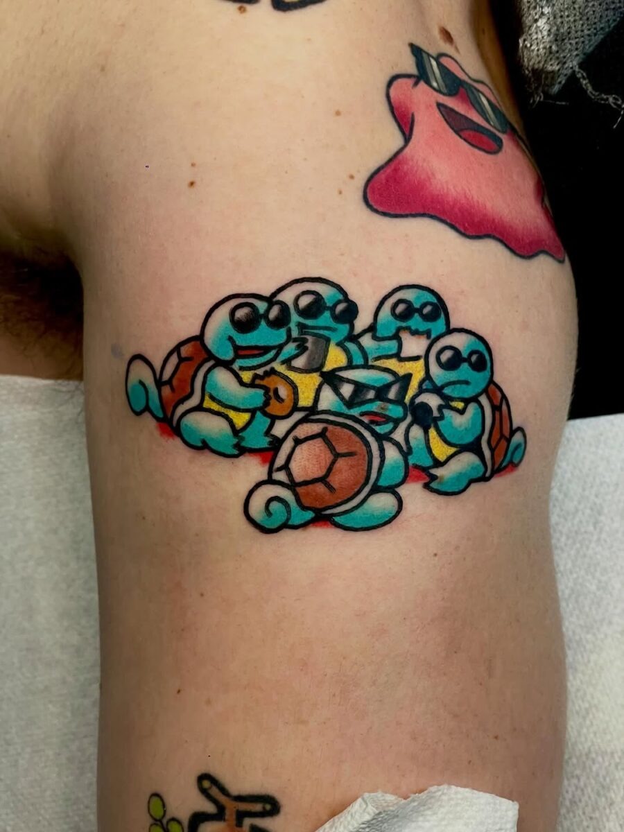 This tattoo showcases a quartet of lively Squirtles having fun together.