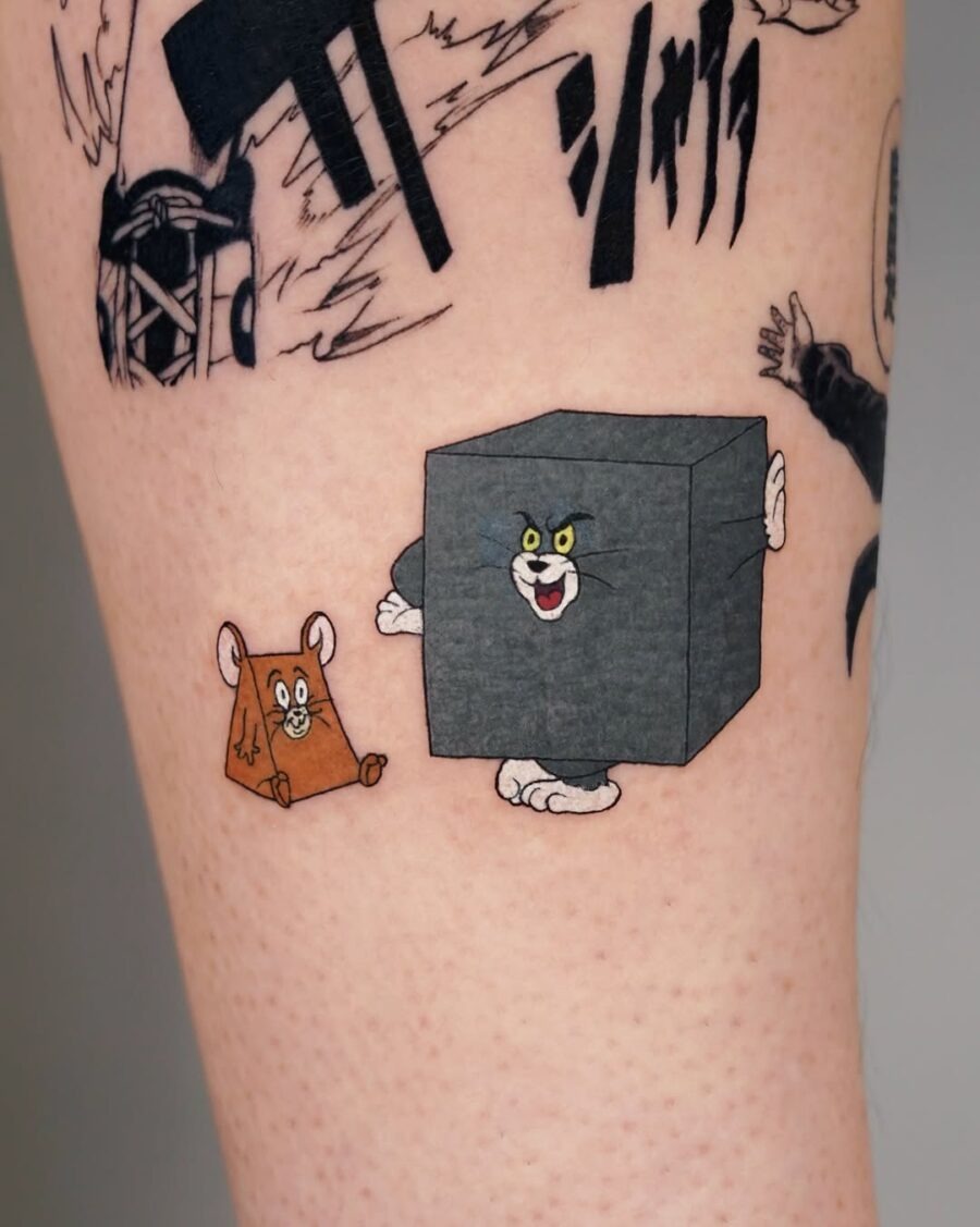 This tattoo showcases the iconic duo, Tom and Jerry, in a playful pose.