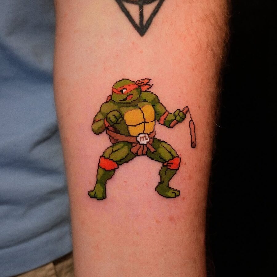 This tattoo showcases a pixelated version of Raphael, the iconic Teenage Mutant Ninja Turtle.