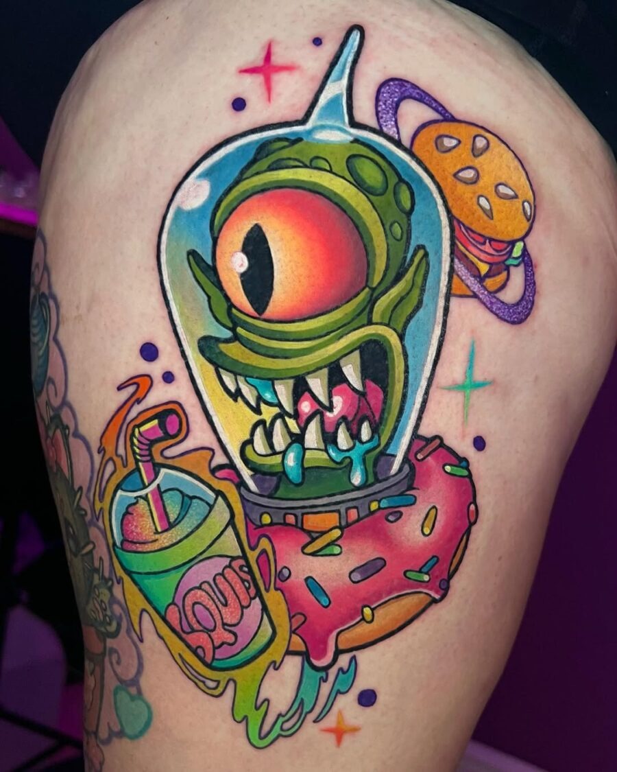 This tattoo showcases a quirky alien inside a glass dome, oozing personality with its vivid colors and exaggerated features.