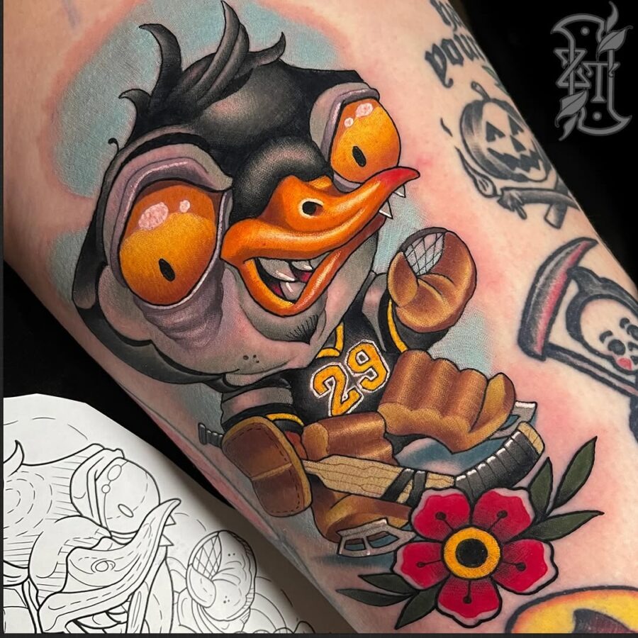 This tattoo features a charming cartoon duck portrayed in a lively style.