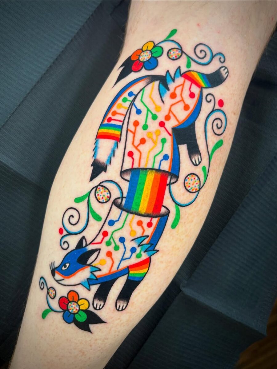 This tattoo showcases a stylish cat elegantly intertwined with colorful circuitry, radiating a playful vibe.