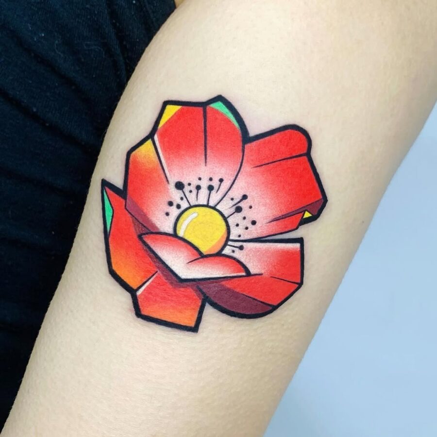 This colorful flower tattoo features bold reds and oranges that pop against the skin.