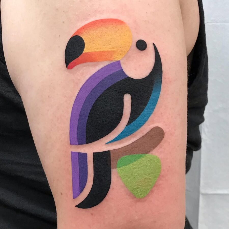 This tattoo features a toucan with bold colors and geometric shapes.