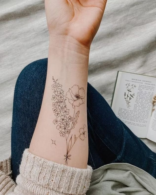 Delicate Wildflower Wrist Bouquet, a tattoo design rendered in fine-line.