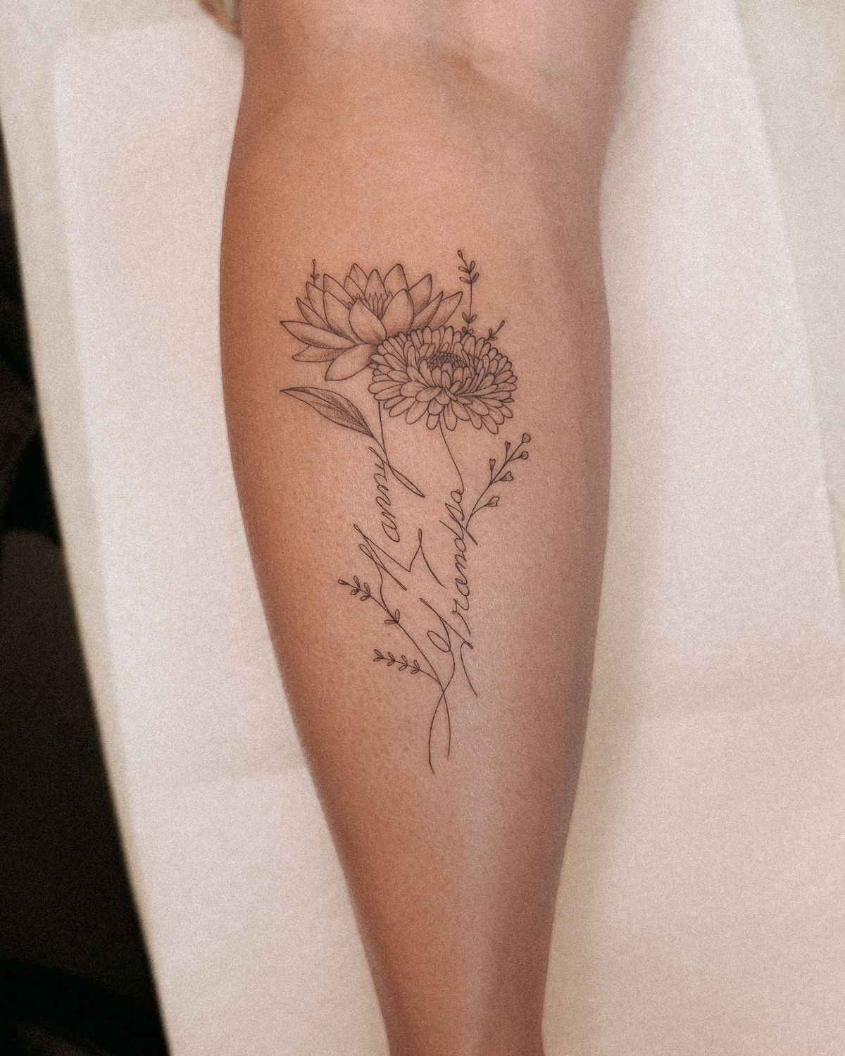 Names with Chrysanthemum and Lotus, a tattoo design rendered in clean detailed linework.