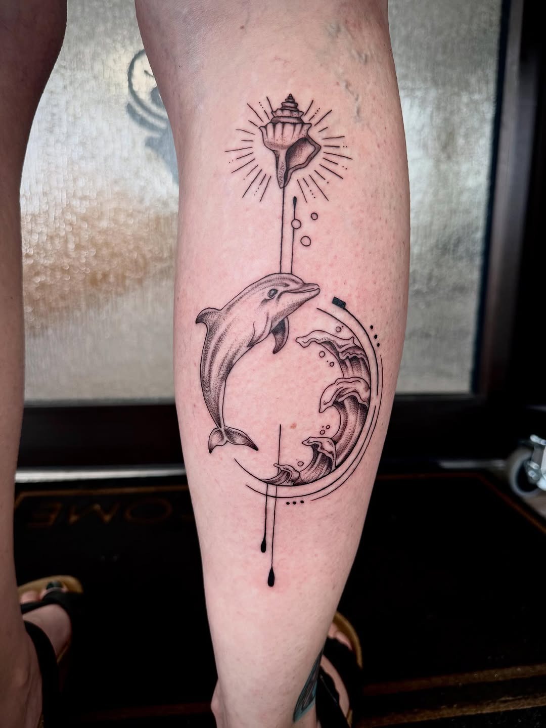 Intricate dolphin and wave tattoo design Tattoo Design